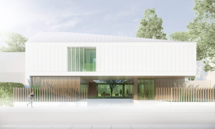 Dom jednorodzinny „Dwa Światy” w Krakowie, kontrast dwóch brył: drewniany parter i jasne, nadwieszone piętro, nowoczesna architektura.